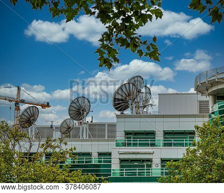 Many Satellite Dishes On Rooftop Of A Communicaitons Building