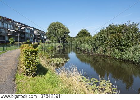 Lokeren, Belgium, July 13, 2020, Apartments Next To The River With Balcony And Awnings
