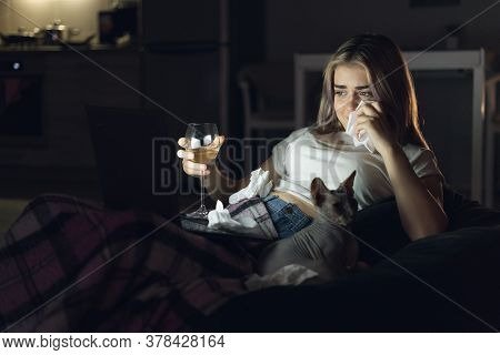 Young Beautiful Woman Watching Movie At Home At Night. A Glass Of White Wine. Melodrama Before Bed.