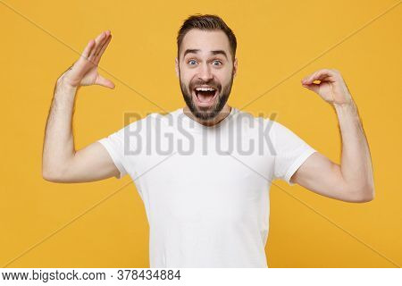 Excited Young Bearded Man Guy 20s In White Casual T-shirt Posing Isolated On Yellow Background Studi