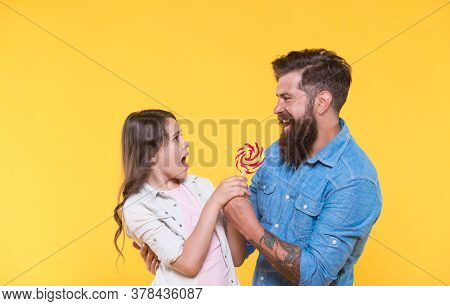 One For Me None For You. Father Take Lollipop From Unhappy Child. Fighting For Swirl Lollipop On Sti