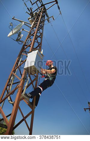Tehnician In Red Helmet Working On Scada Antenna System