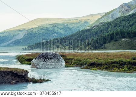 Scenic Alpine Landscape With Big Mossy Stone In Clear Azure Water Of Mountain River. Atmospheric Hig