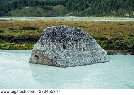 Scenic Alpine Landscape With Big Mossy Stone In Clear Azure Water Of Mountain River. Atmospheric Hig