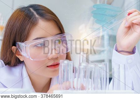 Doctor And Microbiologist With Vacuum Tubes For Samples With Covid 19 Infection Atypical Pneumonia V