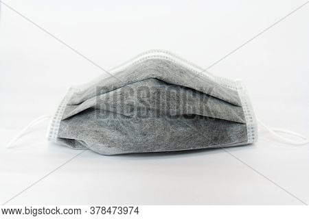 Used Black Medical Face Mask On White Background.coronavirus,covid-19,protec The Virus Concept