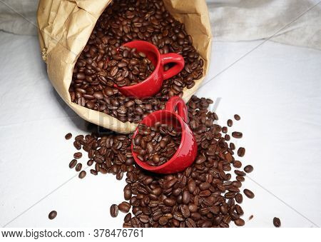 Red Ceramic Espresso Cups In A Paper Bag With Coffee Beans