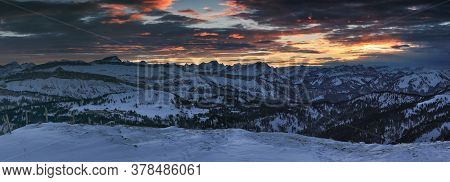 Amazing Sunset Alpenglow Panorama View To Snow Covered Mountain Ranges And Dramatic Sky In Cold Wint