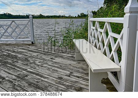 Wooden Jetty With White Fence In Sweden