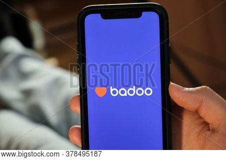 Badoo Application On The Smartphone In Mans Hand. Man Laying And Using Application For Dating And Me