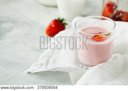 Organic Probiotic Milk Kefir Drink Or Yogurt With Strawberry In Glass On The White Grey Background. 