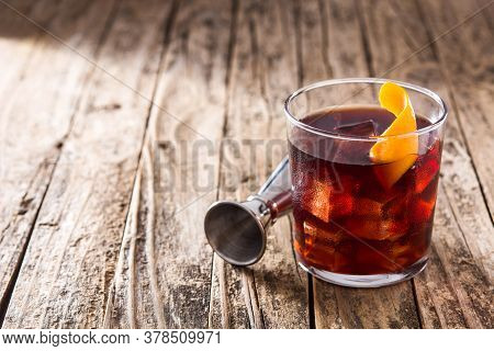 Boulevardier Cocktail And Orange Zest On Wooden Table.copy Space