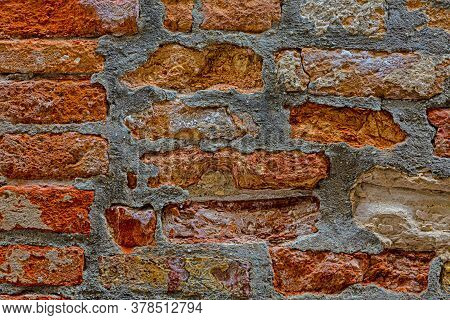 Macro Picture Of Red Colored Natural Brick Wall With Grey Cement Joints