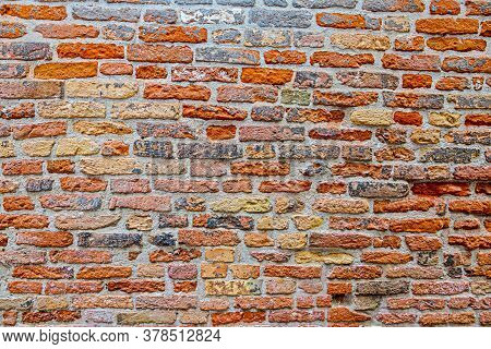 Macro Picture Of Red Colored Natural Brick Wall With Grey Cement Joints