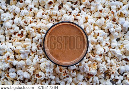 Top View Of Cup Of Tea Placed Among Background Of Homemade Popcorns. Homemade Snack.