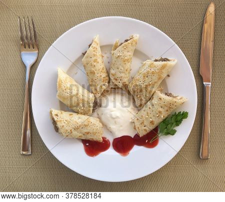 Delicious Sliced Pancakes With Meat And Tomato Sauce.