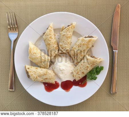 Delicious Sliced Pancakes With Meat And Tomato Sauce.