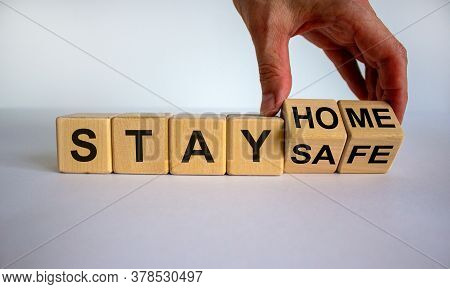 Wooden Cube Form The Expression 'stay Home, Stay Safe'. Male Hand. Beautiful White Background, Copy 