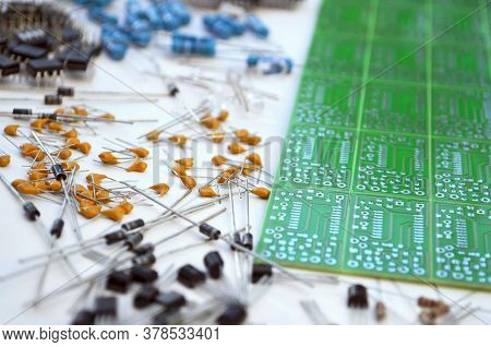 Group Of Different Electronic Components Arranged Near Green Electronic Circuit Board On White Backg