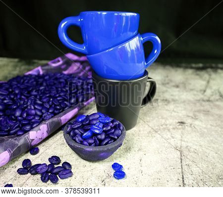 Ceramic Espresso Cups And A Lot Of Coffee Beans On A Concrete Board