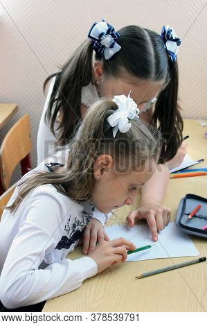 Moscow, Russia - September 1, 2017: Schoolgirls Sitting At The Desk In Class At School, Traditional 
