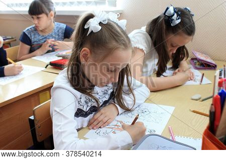 Moscow, Russia - September 1, 2017: Schoolgirls Sitting At The Desk In Class At School, Traditional 