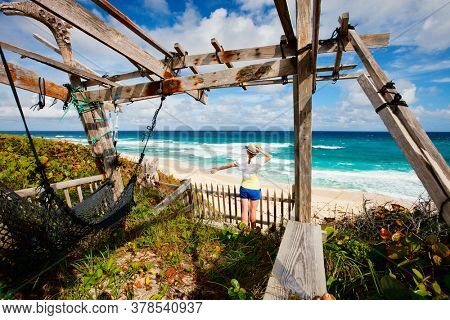 Young woman enjoying view of tropical beach on Eleuthera Bahamas