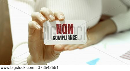 Businesswoman Holding A Card With Text Non Compliance