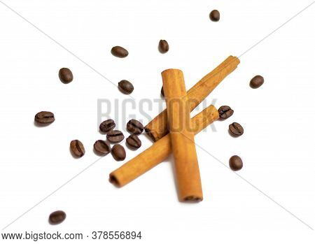 Cinnamon Spice And Coffee Beans Scattered Over A White Background