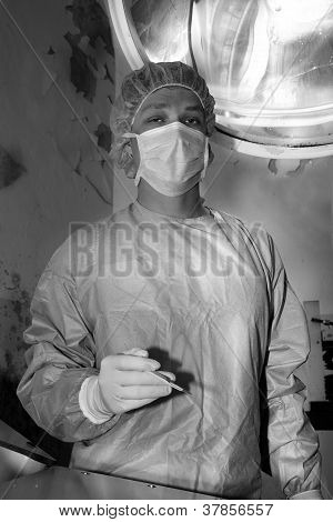 Shaded surgeon standing calmy before coming difficult surgery