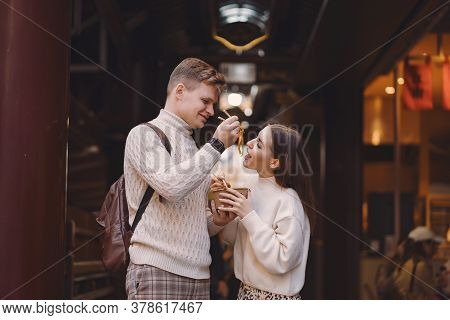 Newlywed Couple Eating Noodles With Chopsticks In Shanghai Outside A Food Market