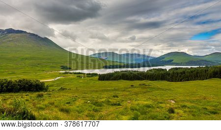 A View Over Glen Tulla With Loch Tulla In The Background, Surrounded By Mountains And Woodland, From