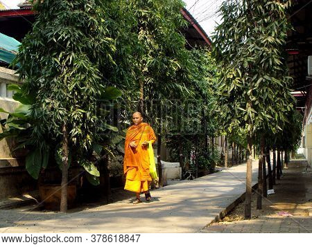 Bangkok, Thailand, February 4, 2013: Buddhist Monk Walks Through A Quiet Street In Bangkok, Thailand