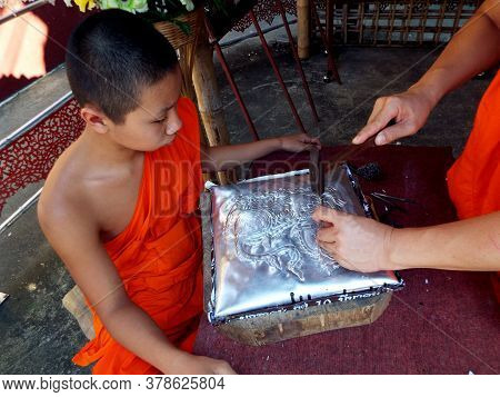 Chiang Mai, Thailand, December 6, 2018: Buddhist Monk Teaches His Student The Art Of Goldsmithing At