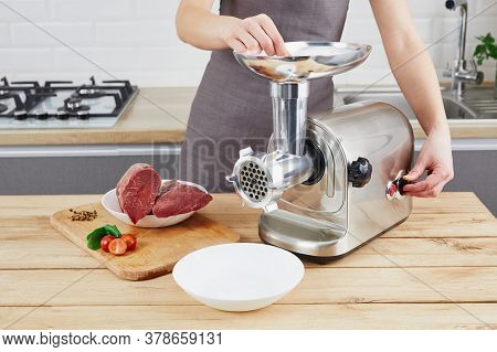 Raw Meat. The Process Of Preparing Forcemeat By Means Of A Meat Grinder. Female Hands Use Meat Chopp