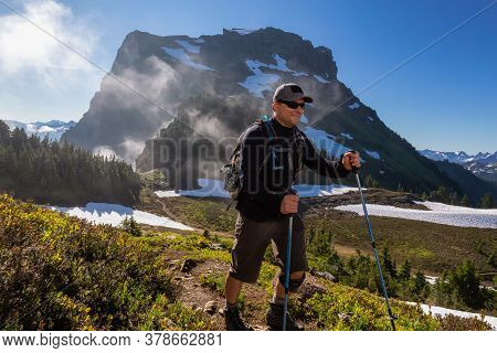 Adventurous Man Hiking In The Canadian Mountains During A Sunny Summer Morning. Taken On The Trail T