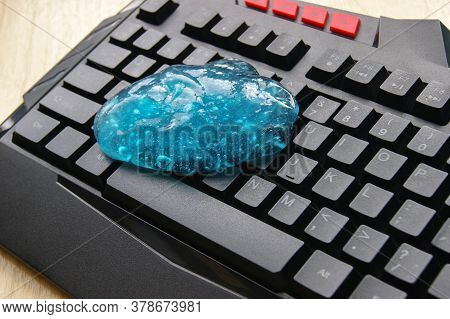 Blue Soft Gel Cleaning Dust On Keyboard. Concept Cleaning Your Computers Keyboard.
