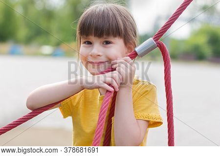 Amasing 6 Years Old Schoolgirl Smils On A Playground