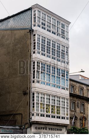 Corunna, Spain - July 20, 2020: View Of House With Wooden Enclosed Balconies In Main Street