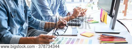 Young Colleagues Designers Working Together On A Creative Project And Color Samples For Selection, C