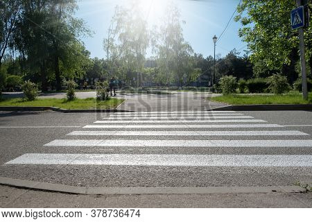 A Crosswalk For Pedestrians Crossing The Street. Empty Crosswalk To The Park
