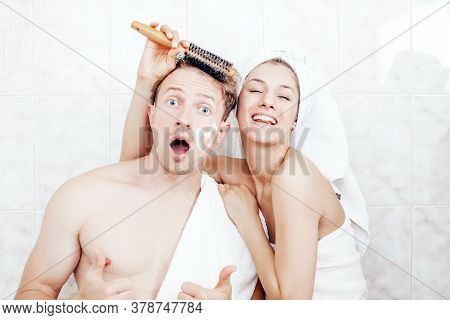 Cuple Standing In Bathroom And Having Morning Routine. Boy And Girl Are Holding A Comb. Happiness. F