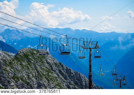 Kanin Mountain In Slovenia, Julian Alps In Summer. Ski Resort And Mountain Hiking Trail. Defocused
