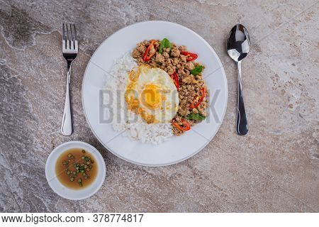 rice topped with stir-fried mince pork and basil with fried egg , Thai famous Street food