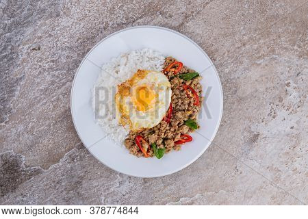 rice topped with stir-fried mince pork and basil with fried egg , Thai famous Street food