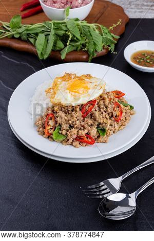 rice topped with stir-fried mince pork and basil with fried egg , Thai famous Street food