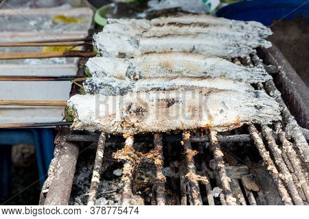 Striped Snakehead Fish Grilled With Salt. Pomegranate Fish With Salt And Then Burned For Sales In Th
