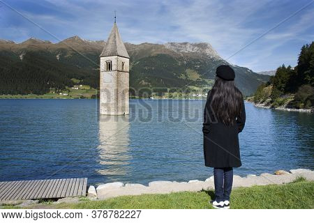 Traveler Asian Thai Woman Travel And Posing For Take Photo At Submerged Tower Of Reschensee Church D