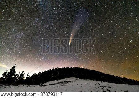 Surreal View Of Night In Mountains With Starry Dark Blue Cloudy Sky And C/2020 F3 (neowise) Comet Wi