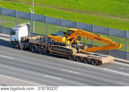 Excavator Hyundai Robex 220 Lc-95 Truck Trailer Loaded Onto Cargo Platformon City Highway. Russia, S
